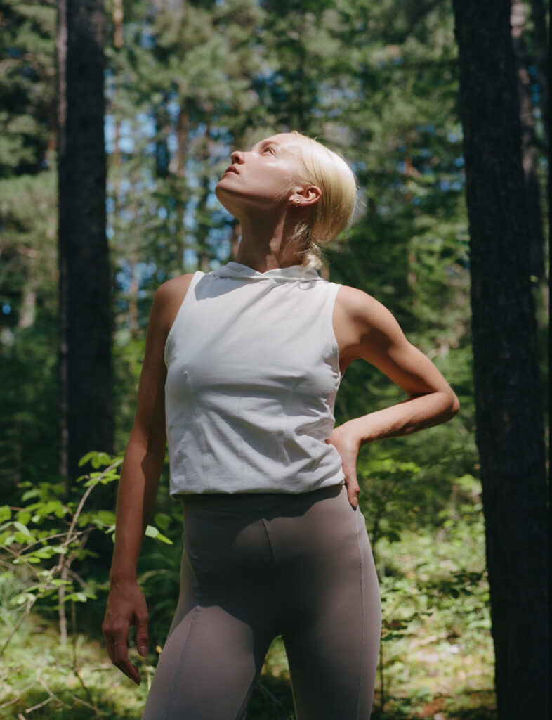 Woman modeling Ernest Leoty clothing in forest.